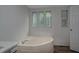 Relaxing bathroom with corner bathtub and neutral color palette at 95 Old Barn Ct, Rocky Mount, NC 27801