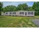 Tan mobile home exterior on a grassy lot at 95 Old Barn Ct, Rocky Mount, NC 27801