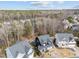 Aerial view of the home and surrounding neighborhood nestled among mature trees at 101 Pointe Park Cir, Holly Springs, NC 27540