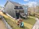 Backyard view of the home with a screened porch, wooden deck, and a playset at 101 Pointe Park Cir, Holly Springs, NC 27540