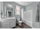 This bathroom has a tile floor, gray walls, shower with curtain, and an updated vanity at 101 Pointe Park Cir, Holly Springs, NC 27540