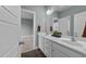 Bathroom with dual sinks, white cabinetry, and a mirror, accessible from the bedroom at 101 Pointe Park Cir, Holly Springs, NC 27540