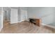 Bedroom with wood-look floors, two closets, and a wooden desk with black chair at 101 Pointe Park Cir, Holly Springs, NC 27540