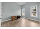 Bright bedroom featuring wood-look floors, a wooden desk, and natural light at 101 Pointe Park Cir, Holly Springs, NC 27540