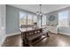 Cozy dining room featuring a large wooden dining table and bench with modern light fixture at 101 Pointe Park Cir, Holly Springs, NC 27540