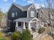 Two-story home with dark siding, a covered front porch, and a side deck at 101 Pointe Park Cir, Holly Springs, NC 27540