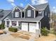 Beautiful two story home featuring a two car garage and covered porch with an American flag at 101 Pointe Park Cir, Holly Springs, NC 27540