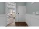 Bright foyer with hardwood floors, wainscoting, and an open view to a sunlit office space at 101 Pointe Park Cir, Holly Springs, NC 27540