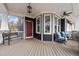 Inviting front porch with seating, an overhead fan, and elegant bay windows at 101 Pointe Park Cir, Holly Springs, NC 27540