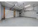 Spacious garage featuring two doors, overhead storage, and ample room for parking at 101 Pointe Park Cir, Holly Springs, NC 27540