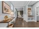 Inviting hallway with stylish decor, wainscoting, and access to the living spaces at 101 Pointe Park Cir, Holly Springs, NC 27540