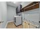 Functional laundry room with modern appliances, storage cabinets, and hanging rack at 101 Pointe Park Cir, Holly Springs, NC 27540