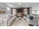 Cozy living room featuring a stone fireplace, plush seating, and ample natural light at 101 Pointe Park Cir, Holly Springs, NC 27540