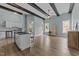 Open-concept kitchen and living area with beams, stainless appliances, and lots of natural light at 101 Pointe Park Cir, Holly Springs, NC 27540