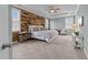 Relaxing main bedroom featuring a wood accent wall, carpet, natural light, and a ceiling fan at 101 Pointe Park Cir, Holly Springs, NC 27540