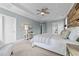 Bright main bedroom with carpet, ceiling fan, recessed lights, and a wood accent wall at 101 Pointe Park Cir, Holly Springs, NC 27540