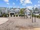 Community playground features swings and is surrounded by landscaping and neighborhood homes at 101 Pointe Park Cir, Holly Springs, NC 27540