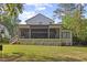 Inviting screened back porch with stairs leading to a landscaped backyard, perfect for outdoor living at 1304 Ivy Ln, Raleigh, NC 27609