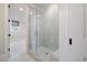 Bathroom featuring glass walk-in shower and a window showcasing a serene outdoor view at 1304 Ivy Ln, Raleigh, NC 27609