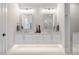 Double vanity bathroom with modern lighting and quartz countertops at 1304 Ivy Ln, Raleigh, NC 27609