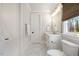 Bright bathroom features marble floors, white cabinetry, and a window providing natural light at 1304 Ivy Ln, Raleigh, NC 27609