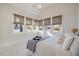 Bright bedroom features a tray ceiling, a large window array with views, and neutral decor at 1304 Ivy Ln, Raleigh, NC 27609