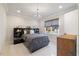 Cozy bedroom with contemporary light fixture and a large window showcasing a serene outdoor view at 1304 Ivy Ln, Raleigh, NC 27609