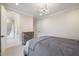 Neutral toned bedroom with industrial dresser and connecting door to bathroom featuring glass enclosed shower at 1304 Ivy Ln, Raleigh, NC 27609