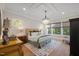 Spacious bedroom with hardwood floors, large windows, and chandelier at 1304 Ivy Ln, Raleigh, NC 27609
