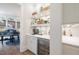 White built-in butlers pantry with beverage center and shelving at 1304 Ivy Ln, Raleigh, NC 27609