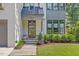 Charming home featuring a brick facade, landscaped garden, and a stylish, modern front door at 1304 Ivy Ln, Raleigh, NC 27609
