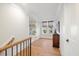 Bright hallway with hardwood floors and a charming wooden cabinet at 1304 Ivy Ln, Raleigh, NC 27609