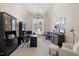 Bright home office with large window, chandelier, and built-in shelving at 1304 Ivy Ln, Raleigh, NC 27609