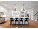 Modern kitchen with white cabinets, large island with seating, and hardwood floors at 1304 Ivy Ln, Raleigh, NC 27609