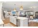 Open concept kitchen with island, stainless steel appliances, and hardwood floors at 1304 Ivy Ln, Raleigh, NC 27609