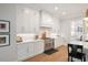 White kitchen with stainless steel appliances and gas range at 1304 Ivy Ln, Raleigh, NC 27609