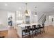 Modern kitchen with white cabinets, a large island, and stainless steel appliances at 1304 Ivy Ln, Raleigh, NC 27609