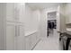 Laundry room with built-in cabinets and access to a closet at 1304 Ivy Ln, Raleigh, NC 27609