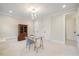 Office area featuring modern glass desk, stylish chair, and seamless access to a luxurious bathroom at 1304 Ivy Ln, Raleigh, NC 27609
