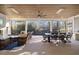 An outdoor living area with fireplace and furniture set, dining area, and retractable screens at 1304 Ivy Ln, Raleigh, NC 27609