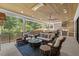Relax on the patio with an outdoor kitchen and seating area with wooded backyard views at 1304 Ivy Ln, Raleigh, NC 27609