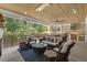 Relax on the patio with an outdoor kitchen and seating area with wooded backyard views at 1304 Ivy Ln, Raleigh, NC 27609