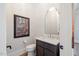 Elegant powder room with marble vanity and decorative mirror at 1304 Ivy Ln, Raleigh, NC 27609