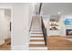 Elegant staircase with wooden treads and a modern metal railing at 1304 Ivy Ln, Raleigh, NC 27609