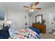 Bright bedroom featuring a queen bed and built-in closet at 2120 Blue Iris Way, Zebulon, NC 27597