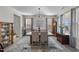 Elegant dining room with a large chandelier, hardwood floor, and large windows at 2120 Blue Iris Way, Zebulon, NC 27597