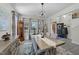 Bright dining room with hardwood floors, chandelier, and views into the entryway at 2120 Blue Iris Way, Zebulon, NC 27597