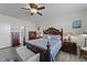 Main bedroom with king-size bed, ceiling fan, and ensuite bathroom at 2120 Blue Iris Way, Zebulon, NC 27597