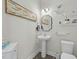 Stylish powder room with pedestal sink and decorative shelving at 2120 Blue Iris Way, Zebulon, NC 27597