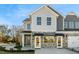 Two-story townhome with gray siding, stone accents, and a covered porch at 2332 Sugar Cone Way, Fuquay Varina, NC 27526